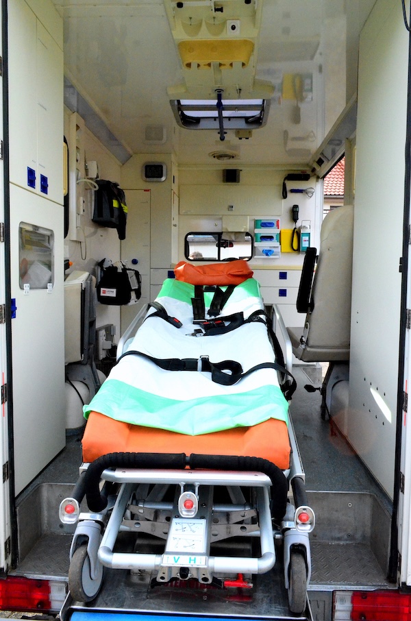 Empty ambulance stretcher, representing the emergency risk of untreated autonomic dysreflexia